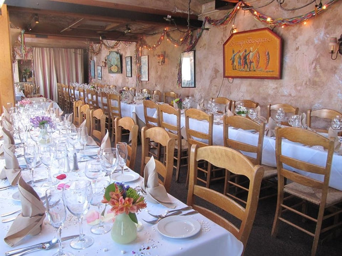 Stone-walled private dining room at Fandango Restaurant set up for a wedding reception dinner