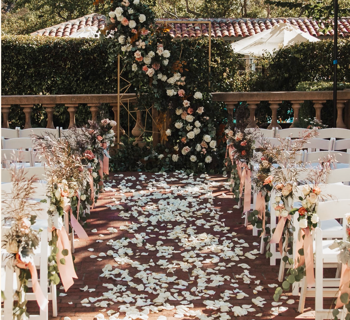 Wedding floral arch and aisle petals at La Playa Hotel