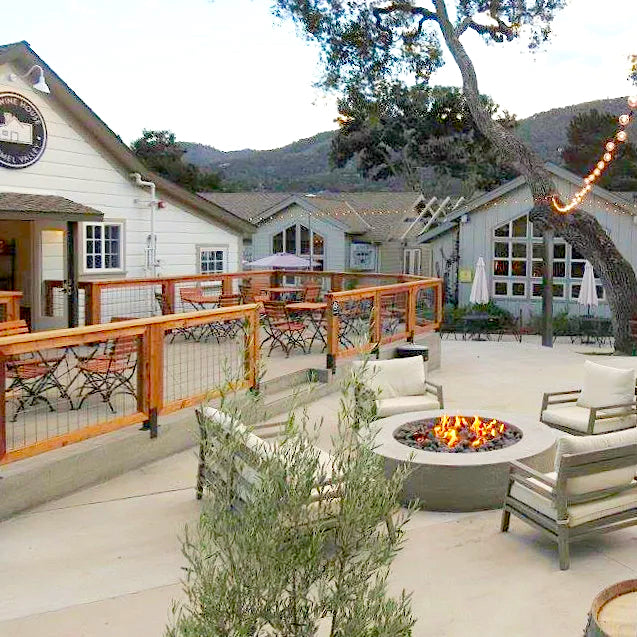 The Wine House patio in Carmel Valley with fire pit and cozy lounge chairs and views of the Santa Lucia mountains